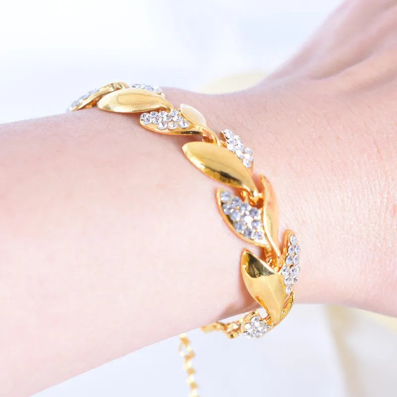 Pulseira feminina folheado a ouro com pedrinhas brilhantes de cristal.  Ajustável  no braço.